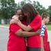 Willow Run Middle School teachers Marshall Lambert (left) and Sue Littlefield embrace while waving goodbye to their students, Friday June 7.
Courtney Sacco I AnnArbor.com  